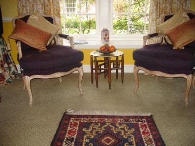 The Dovecote - Armchairs by the window, looking out onto the garden - larger image